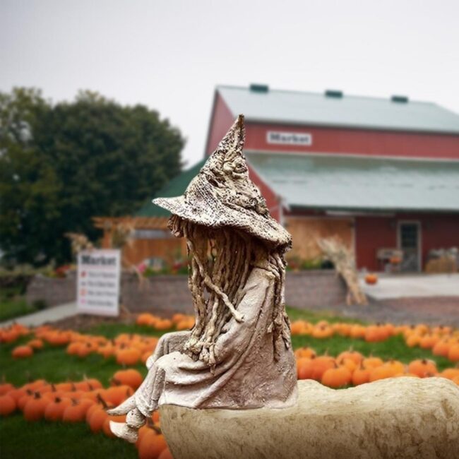 Witch Statue Amidst the Pumpkin Patch