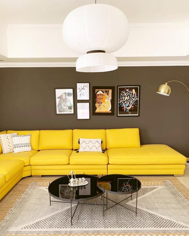 Bold Black Glass Coffee Table Complemented by Yellow Sofa