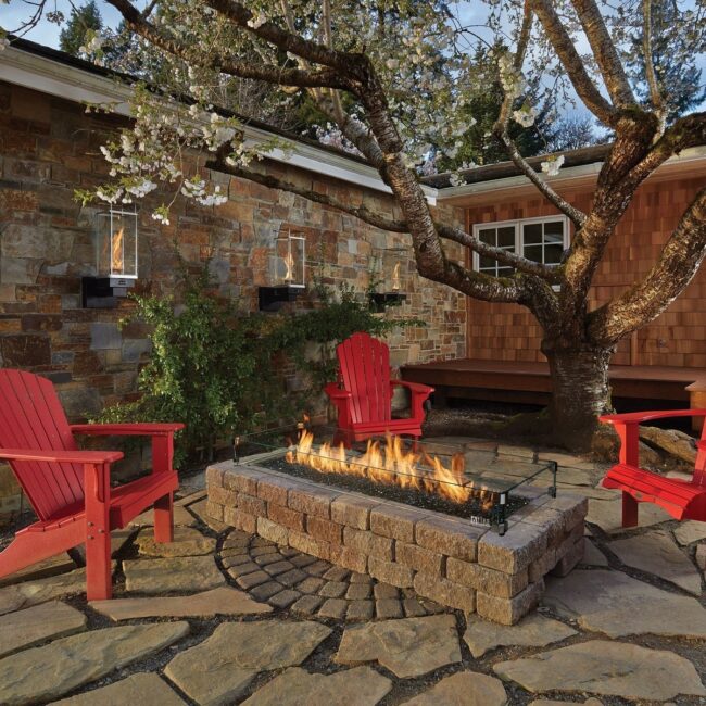 Rustic Fire Pit with Bold Red Chairs