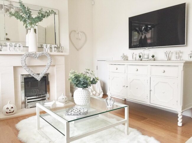 All-White Living Room Featuring Glass Coffee Table