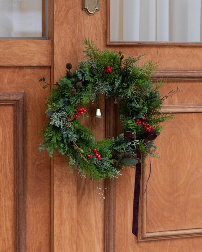 A Traditional Green Wreath with Red Berries & Bells