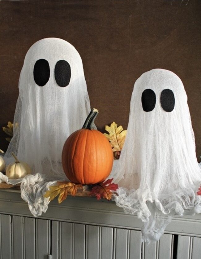 Ghost Pair Illuminated with Pumpkin Light