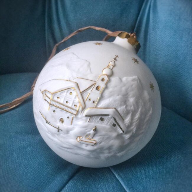 A Delicate White Ornament with a Snowy Scene