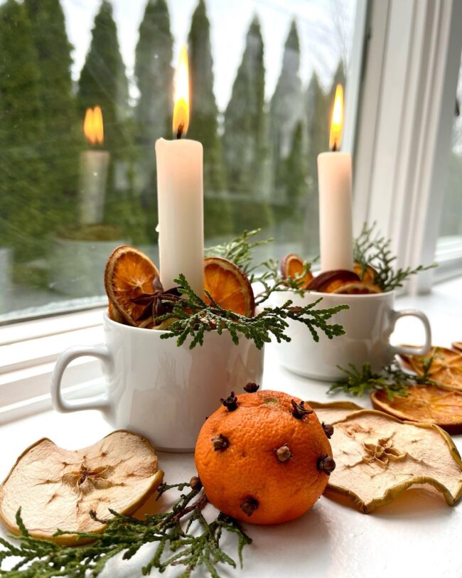 A Candle Display with Citrus & Evergreen Touches