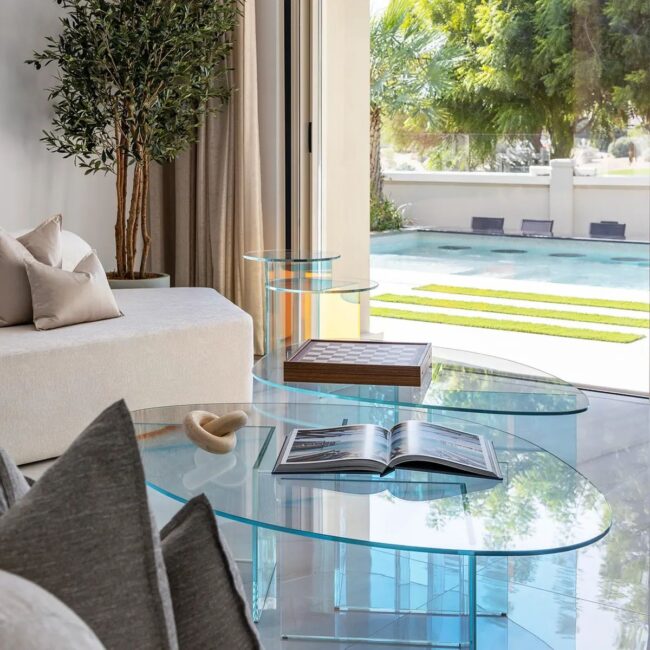 Clear Glass Tables Placed by the Poolside