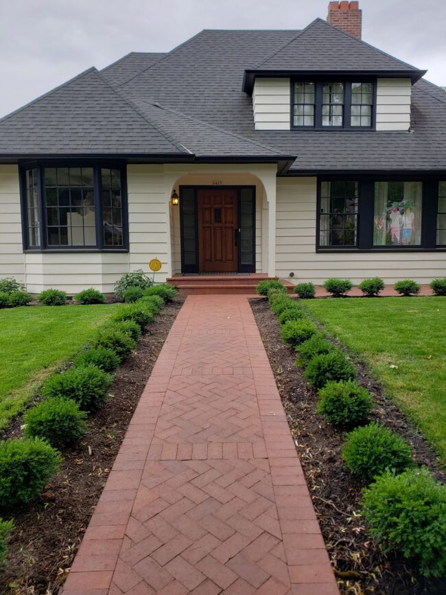 A Brick Walkway Framed by Boxwoods