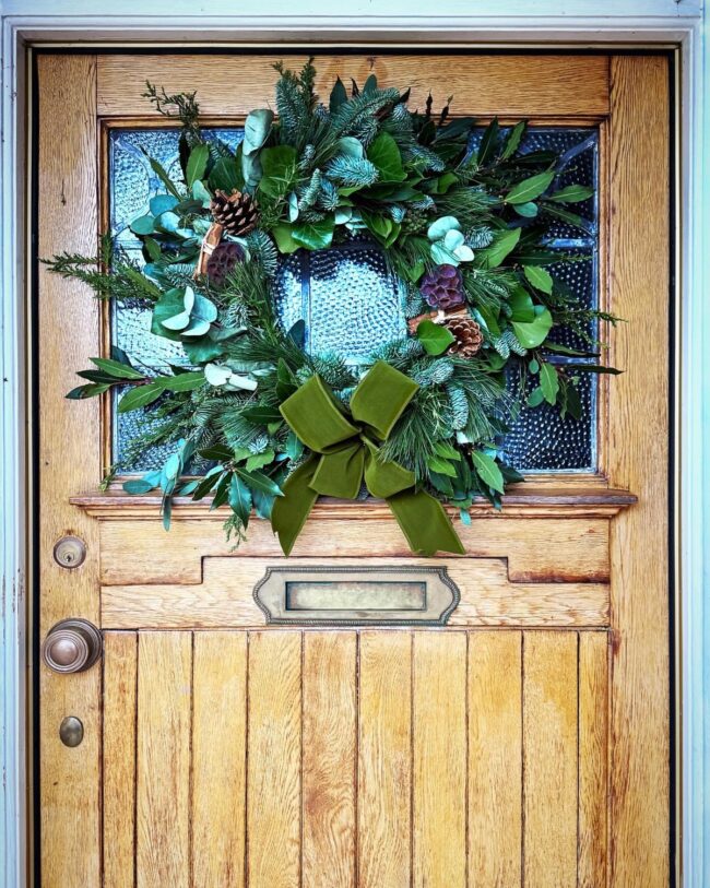 A Grand Evergreen Wreath with a Velvet Bow